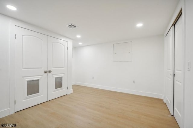 basement with light hardwood / wood-style floors