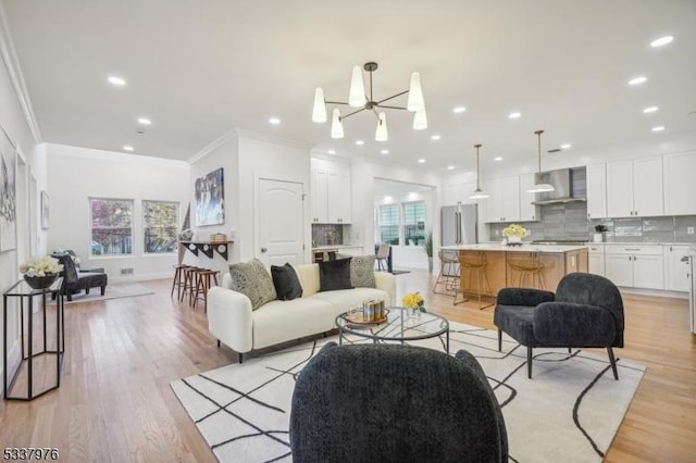 living room featuring a wealth of natural light, light hardwood / wood-style flooring, and ornamental molding