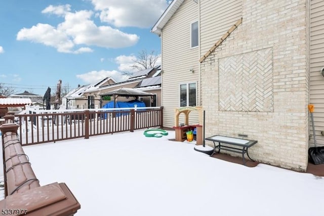 snow covered deck featuring a gazebo