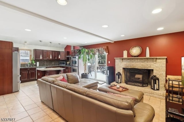 tiled living room featuring a brick fireplace