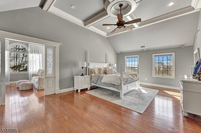 bedroom with beam ceiling, ornamental molding, baseboards, and hardwood / wood-style floors