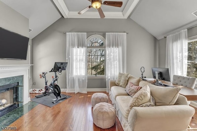 living room with visible vents, vaulted ceiling with beams, a fireplace, ceiling fan, and hardwood / wood-style flooring