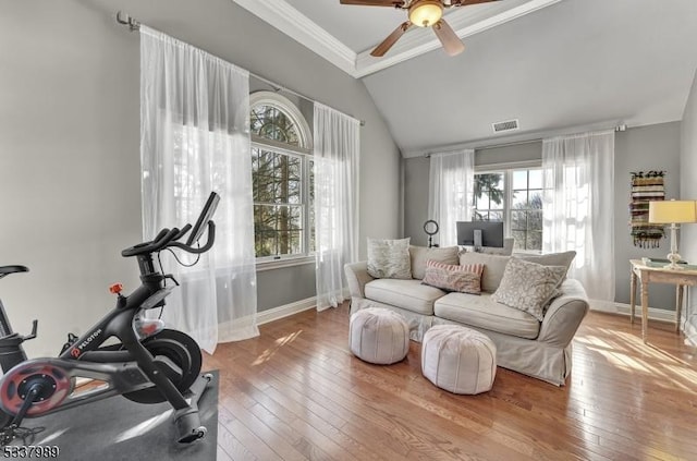 exercise area with visible vents, baseboards, vaulted ceiling, and hardwood / wood-style flooring