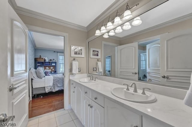 full bathroom with tile patterned floors, crown molding, double vanity, and a sink