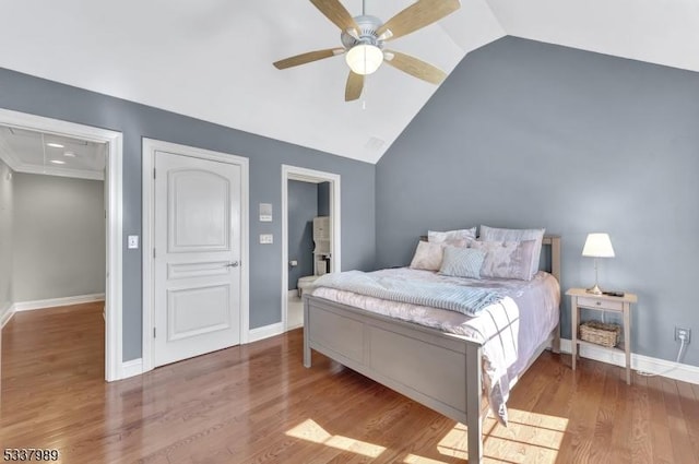 bedroom featuring vaulted ceiling, wood finished floors, baseboards, and ceiling fan