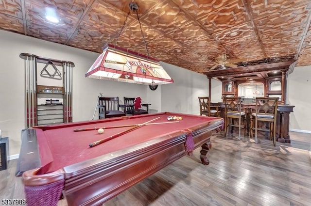 recreation room with billiards, wood finished floors, baseboards, and an ornate ceiling