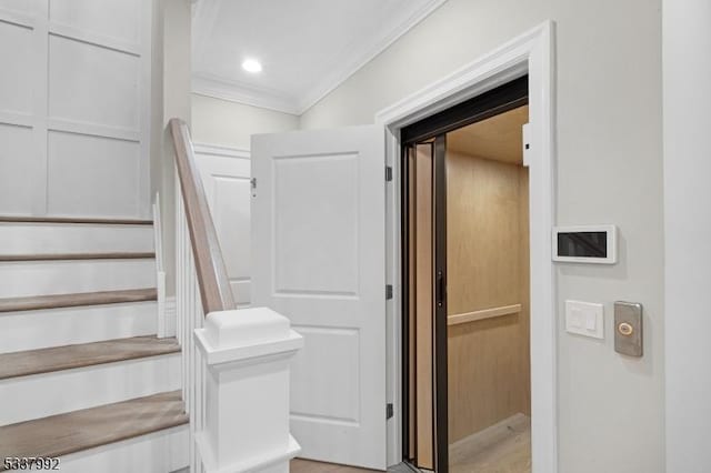 staircase featuring ornamental molding and recessed lighting