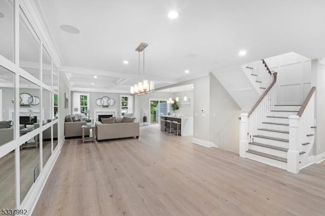 unfurnished living room featuring light wood-style floors, recessed lighting, a fireplace, and stairway