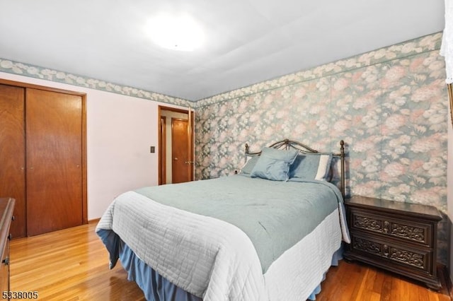 bedroom featuring hardwood / wood-style floors and a closet