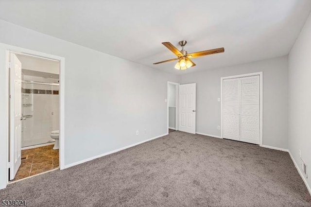 unfurnished bedroom featuring ceiling fan, ensuite bath, carpet floors, and a closet