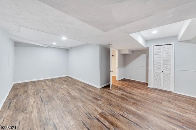 basement with hardwood / wood-style floors