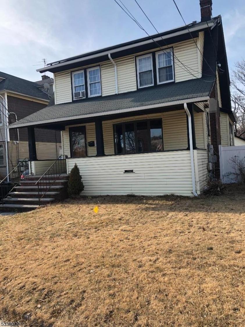 view of front of house with a front lawn and a chimney