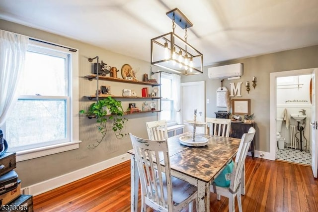 dining room featuring dark wood-type flooring and a wall unit AC