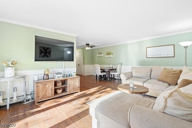 living room featuring crown molding, dark hardwood / wood-style floors, and ceiling fan