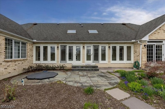 94 Brookville Hollow Rd, Delaware Twp, NJ 08559 - back of property with brick siding, french doors, a patio area, and roof with shingles