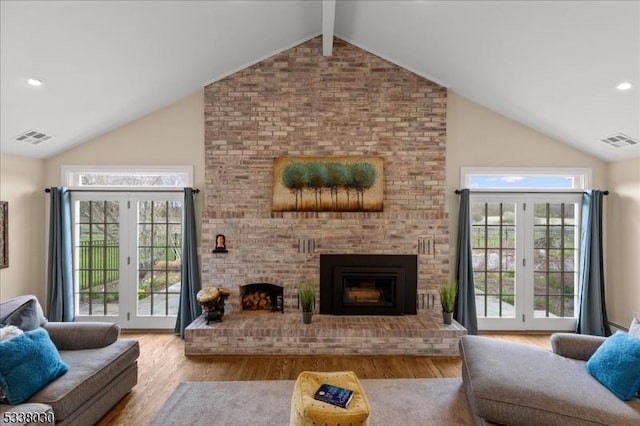 94 Brookville Hollow Rd, Delaware Twp, NJ 08559 - living area with visible vents, a fireplace, wood finished floors, and high vaulted ceiling