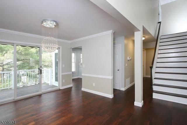 unfurnished living room featuring ornamental molding, dark wood-type flooring, and an inviting chandelier