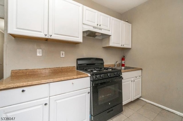 kitchen featuring white cabinetry, sink, light tile patterned flooring, and gas stove