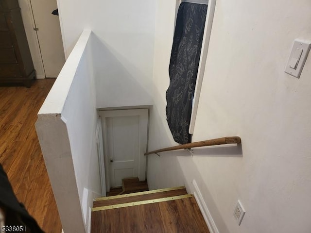 stairs with hardwood / wood-style floors