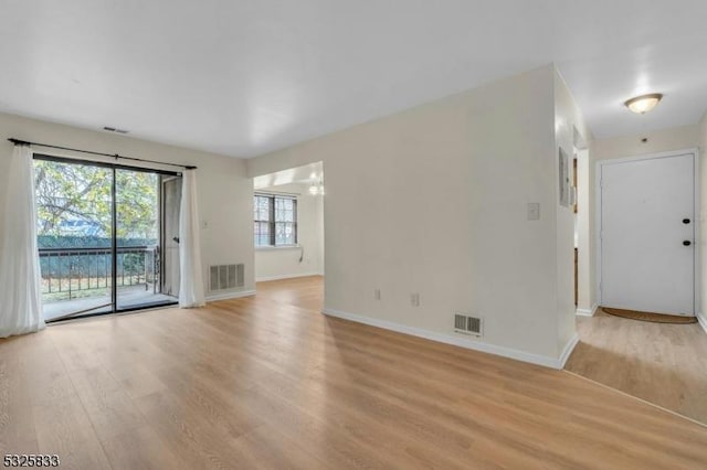 unfurnished living room featuring visible vents and light wood finished floors