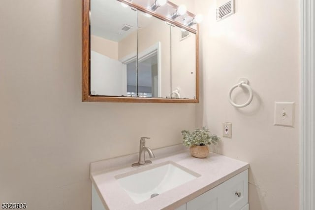 bathroom with vanity and visible vents