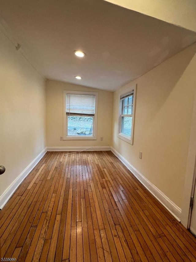 empty room with hardwood / wood-style flooring