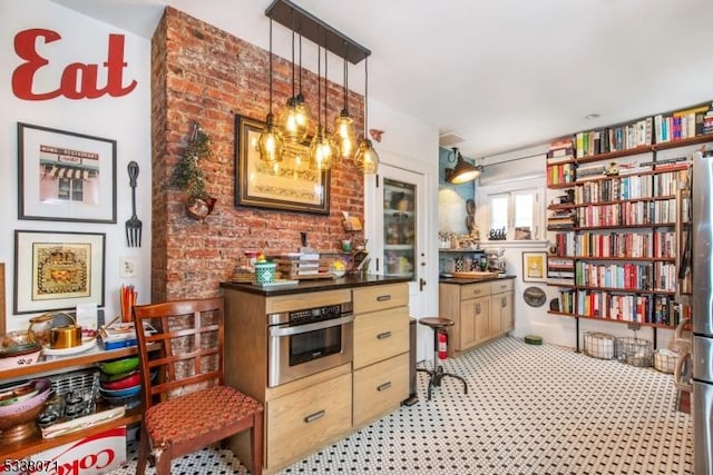 kitchen featuring stainless steel oven and decorative light fixtures