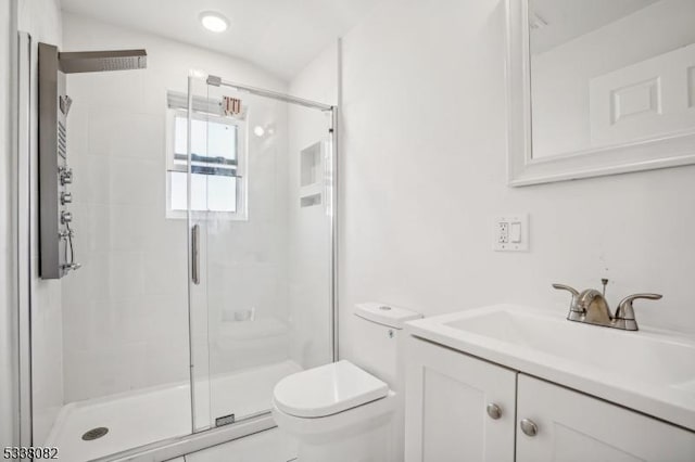 bathroom featuring walk in shower, vanity, and toilet