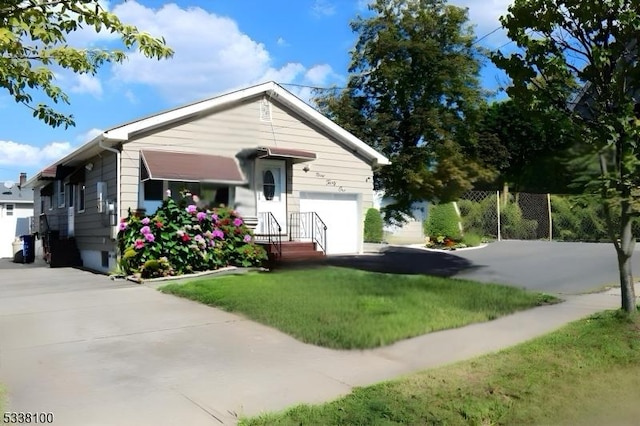 ranch-style home with driveway, a garage, and a front yard