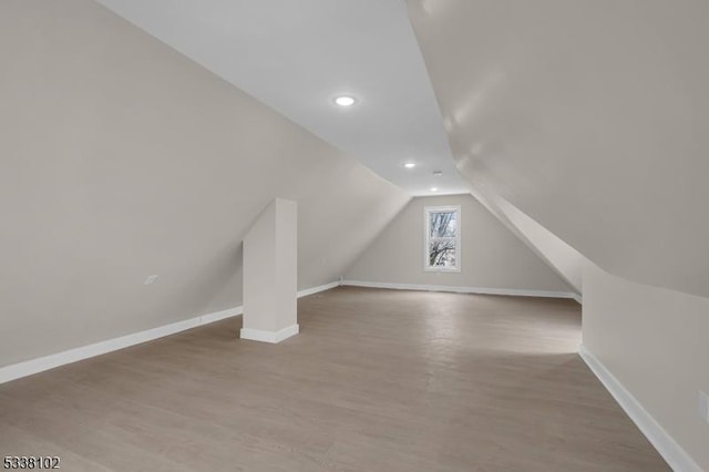 bonus room featuring hardwood / wood-style flooring and vaulted ceiling