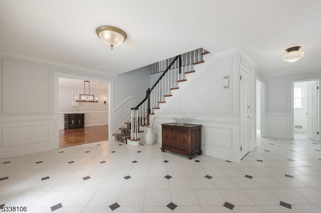 foyer featuring crown molding