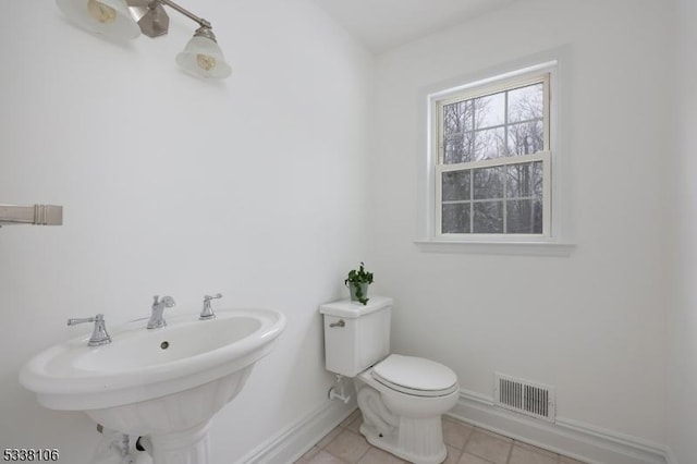 bathroom with tile patterned flooring, sink, and toilet