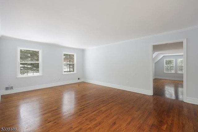 empty room with hardwood / wood-style floors and ornamental molding