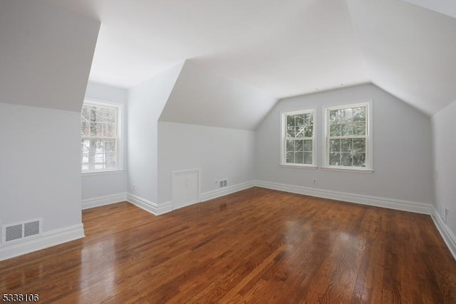 bonus room with hardwood / wood-style flooring and lofted ceiling