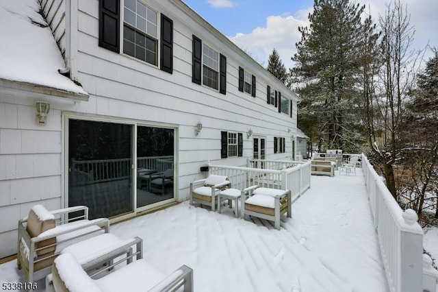 snow covered property with a wooden deck