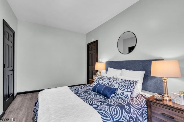 bedroom with hardwood / wood-style flooring