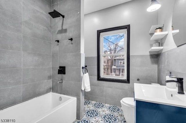 bathroom with vanity, tile walls, tile patterned floors, and toilet