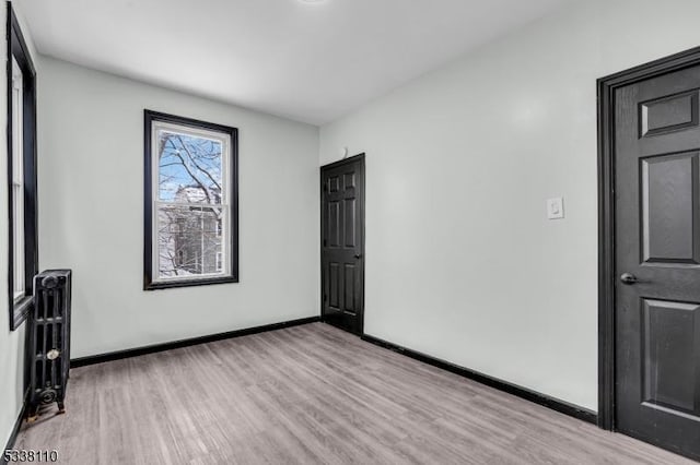 unfurnished room featuring light hardwood / wood-style floors