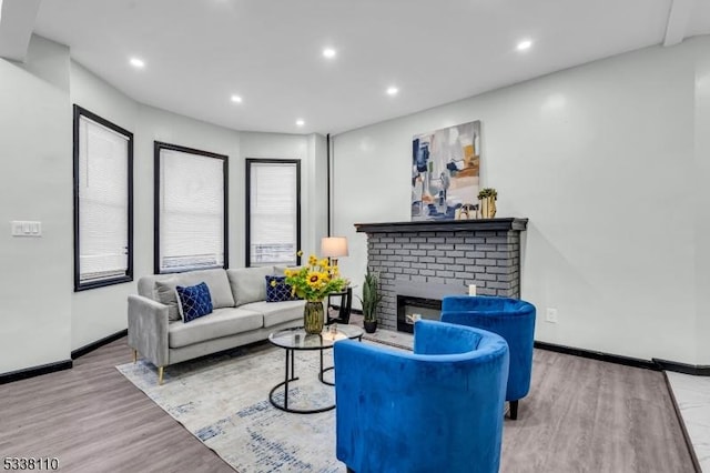 living room with a fireplace and light hardwood / wood-style flooring