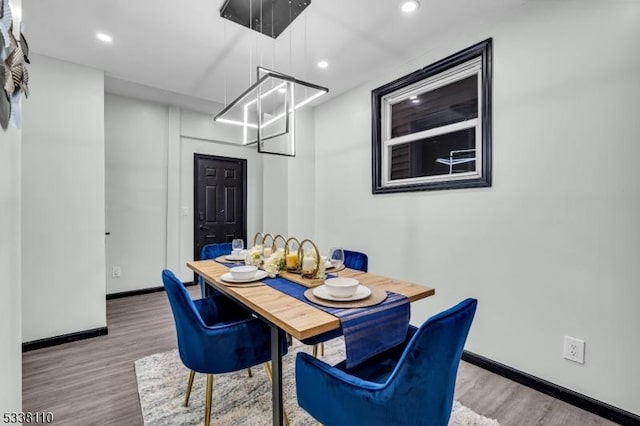 dining space with hardwood / wood-style floors