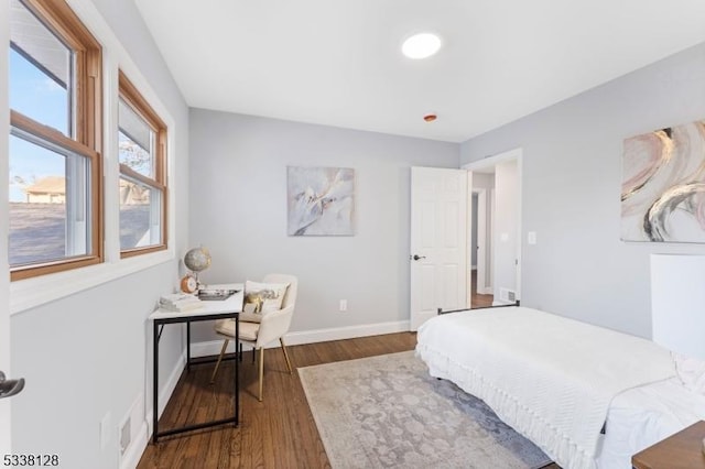 bedroom featuring wood finished floors and baseboards