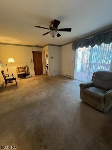 living area with ceiling fan, ornamental molding, carpet flooring, and a baseboard radiator