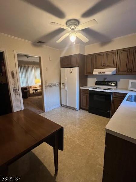 kitchen with white appliances, dark brown cabinets, ceiling fan, and ornamental molding