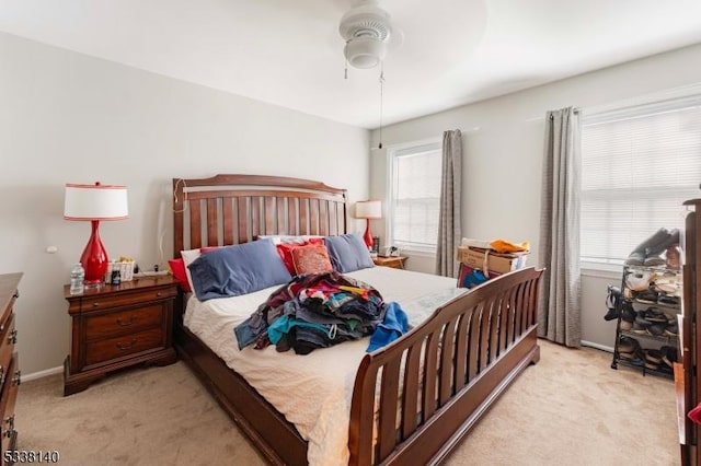 bedroom featuring light carpet and ceiling fan