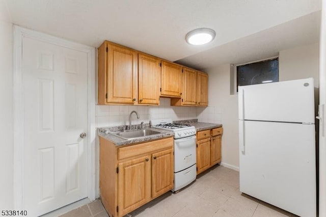 kitchen with sink, white appliances, and decorative backsplash