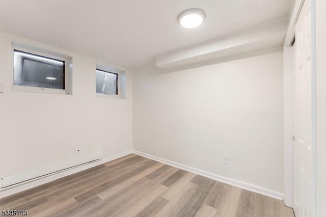 basement with light hardwood / wood-style flooring