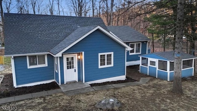 view of front of property featuring a sunroom