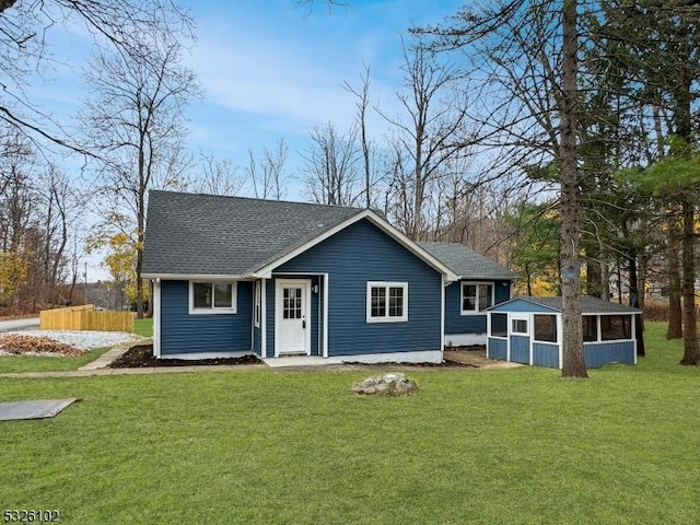 single story home with a front lawn and a sunroom