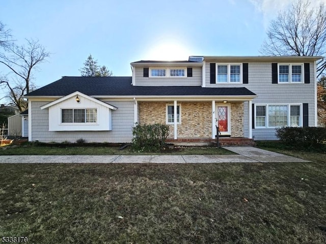 traditional-style home with a front lawn