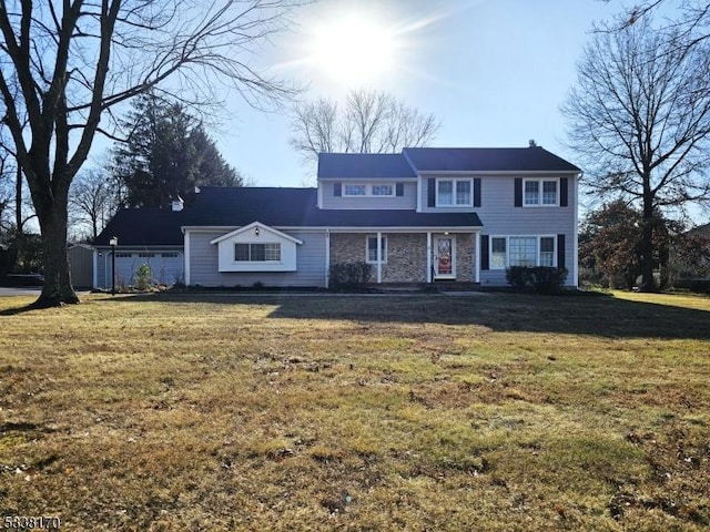 view of front of home with stone siding and a front yard